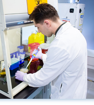 Research student pipetting onto an agar plate.